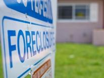 Foreclosure Prevention photograph of a foreclosure sign in front of a house