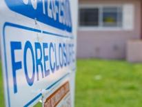 photograph of a foreclosure sign in front of a house