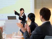 photo of woman giving presentation to small group