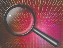 magnifying glass over background of computer code
